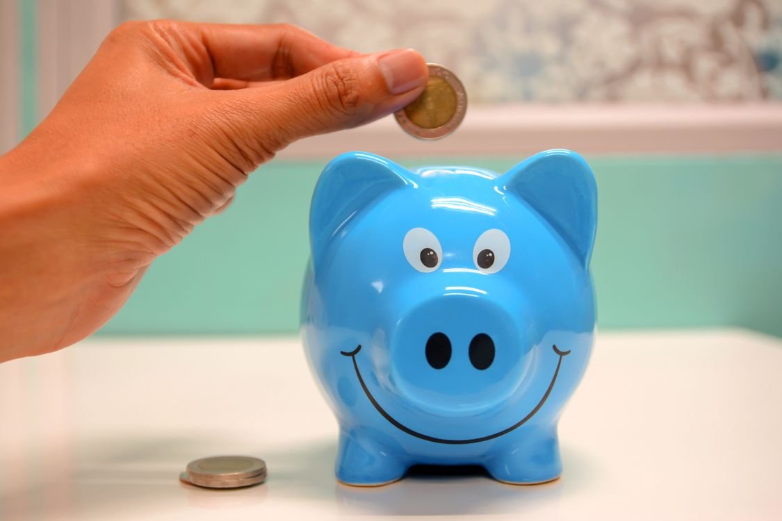 Building passive income with monthly dividend stocks - piggy bank and savings representing monthly income investing strategy